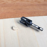 3/8 inch plug cutter drill bit on wood surface with a cut wood plug nearby for woodworking