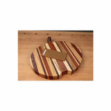 Round striped wood cutting board with handle and rectangular scraper on workbench