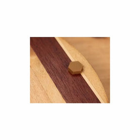 Hexagonal wood plug inlay on striped wooden surface, woodworking detail