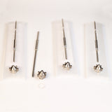 Set of four metal woodworking router bits with pointed tips and fluted ends on white background