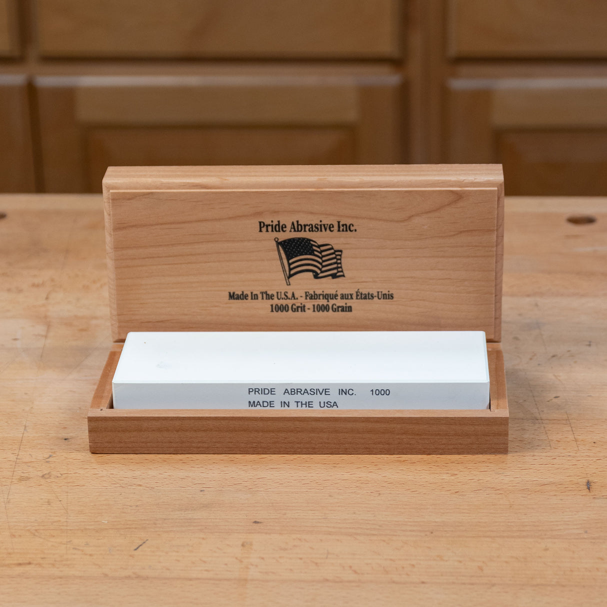 1000 grit sharpening stone in wooden box on workbench, ideal for woodworking tools