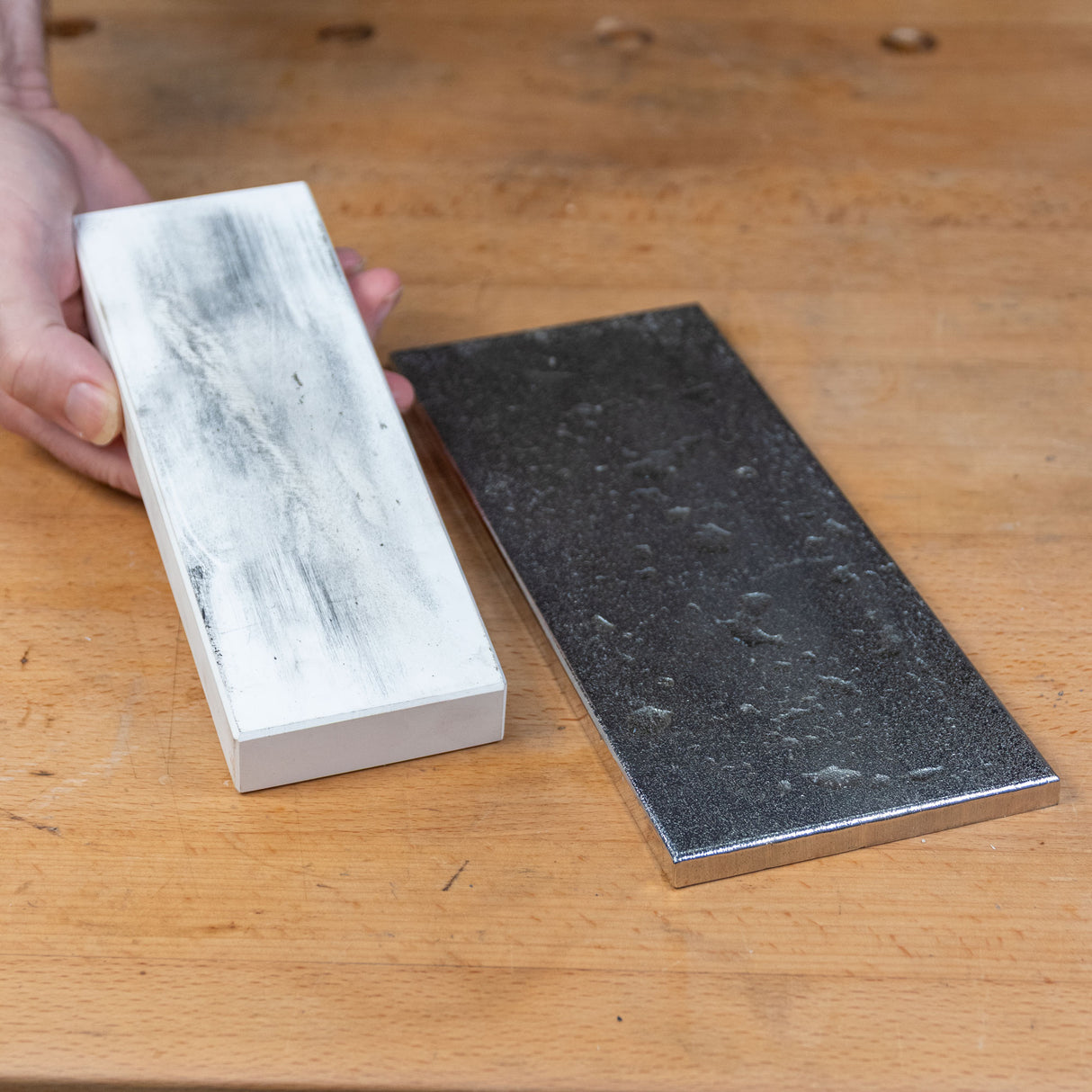 Sharpening stone and diamond plate on woodworking bench for tool maintenance