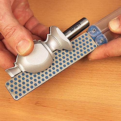 Sharpening a router bit on a diamond honing stone for woodworking tools