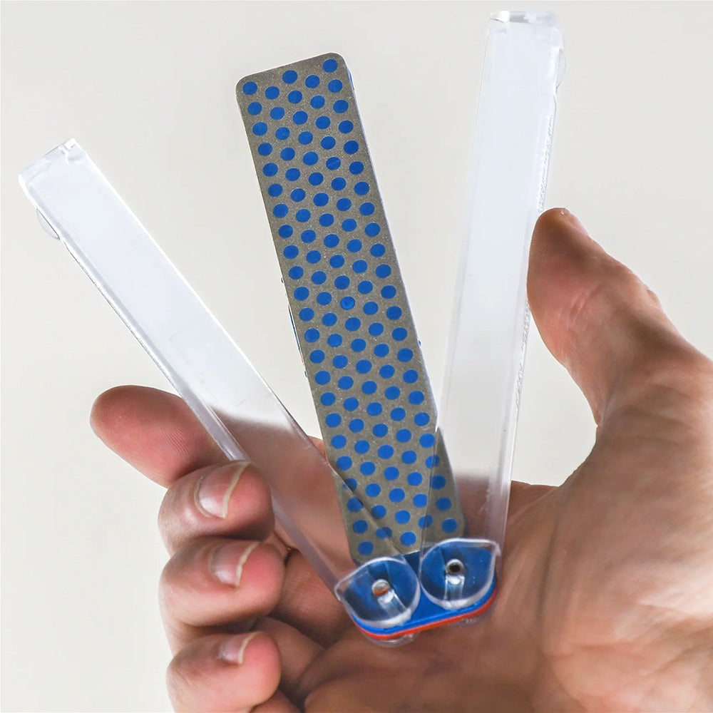 Hand holding a folding diamond sharpening stone for woodworking tool maintenance
