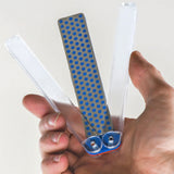 Hand holding a folding diamond sharpening stone for woodworking tool maintenance