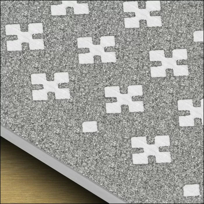 Close-up of abrasive sanding sheet with patterned holes for dust extraction