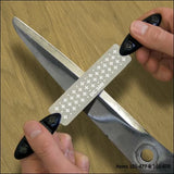 Hand sharpening large scissors with a DC-300 diamond sharpening stone on wood surface.