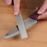 Sharpening a kitchen knife with a diamond sharpening stone on a wooden surface