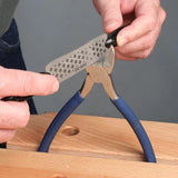 Sharpening wire cutters with a diamond sharpening tool on a wooden workbench
