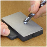 Hand sharpening drill bit on diamond bench stone for woodworking tool maintenance