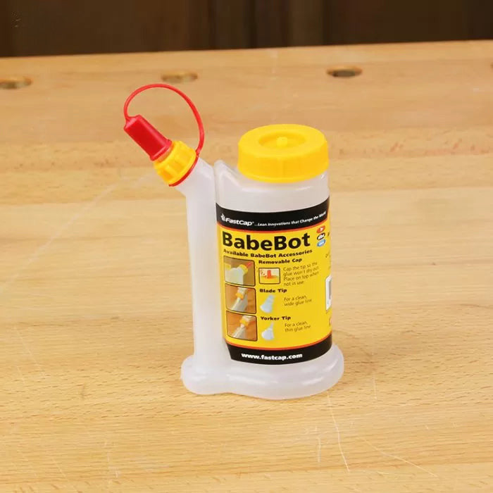 FastCap BabeBot precision glue bottle with yellow cap on a woodworking bench