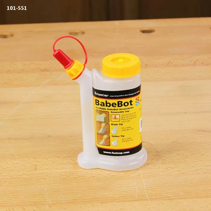 BabeBot glue bottle with yellow lid and applicator tip on a woodworking bench