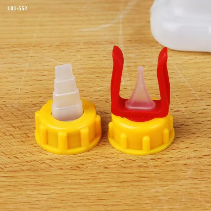 Glue bottle tips with yellow caps for woodworking on a wooden surface