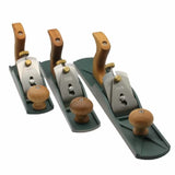 Set of three woodworking hand planes with wooden handles and metal bodies on white background