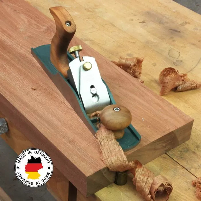 Woodworking hand plane smoothing wood on workbench, wood shavings, made in Germany badge