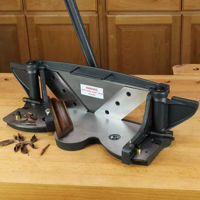 Woodworking miter trimmer tool on workbench with cut molding and shavings