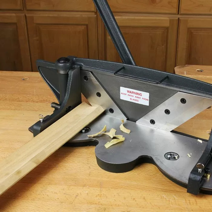 Wood trim cutter tool on workbench with wooden strip and wood shavings