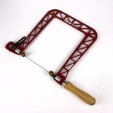 Red aluminum woodworking fret saw with wooden handle on white background