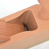 Close-up of a wooden hand plane woodworking tool with exposed blade detail