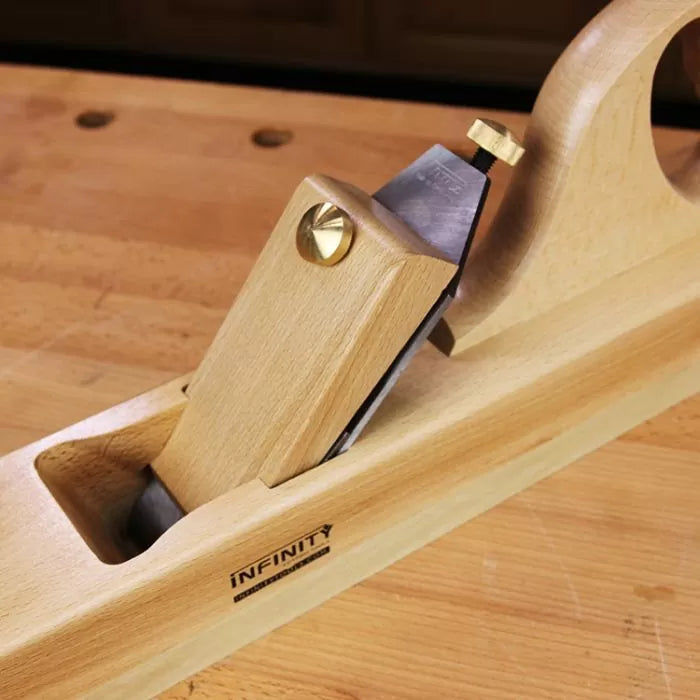 Wooden hand plane tool with blade for woodworking on a workbench