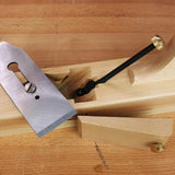 Wooden hand plane with exposed blade and lever cap on a woodworking bench