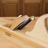 Wood jointer hand plane for woodworking on a workbench, close-up of blade and brass knob
