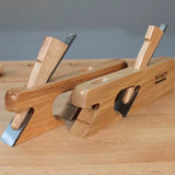 Wooden hand planes with steel blades on a woodworking bench