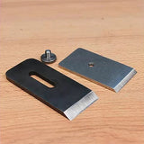 Woodworking plane replacement blades and screw on a wooden surface