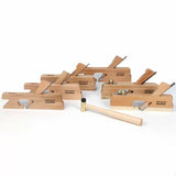 Set of wooden hand planes with brass mallet for woodworking on white background