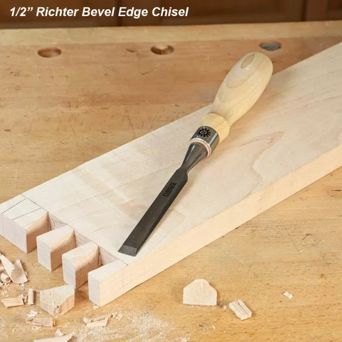 Half inch bevel edge chisel with wooden handle on a workbench and dovetailed wood board.