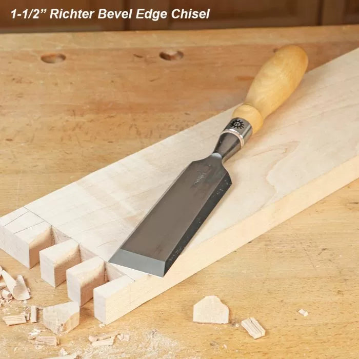 Richter bevel edge chisel on woodworking bench next to dovetail joints and wood shavings