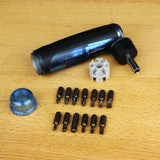 Multi-bit screwdriver set with handle, various screwdriver bits, holder, and cap on wood surface