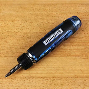 Multi-bit screwdriver with ergonomic handle on wooden surface