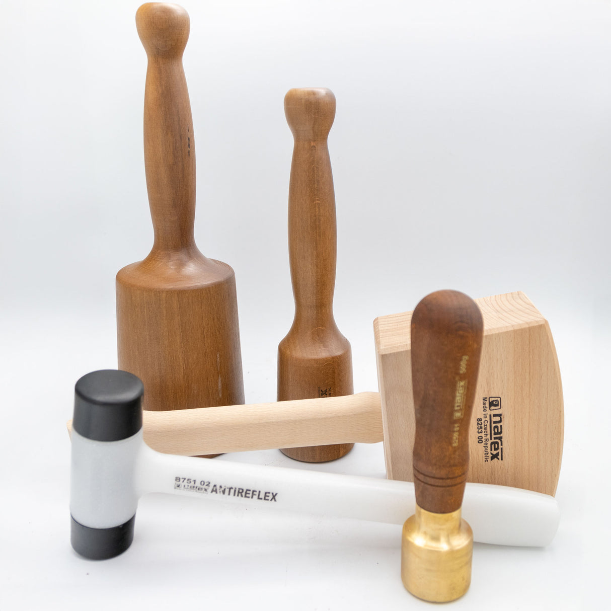 Assorted woodworking mallets and hammers on white background, ideal for wood carving