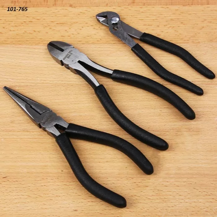 Set of three black-handled pliers on wooden surface, including needle-nose and diagonal pliers