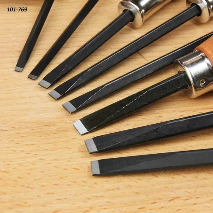 Set of woodworking chisels with square tips arranged on a wooden surface