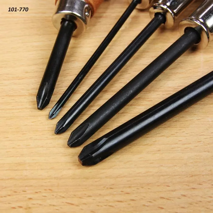 Close-up of five Phillips screwdrivers with black shafts on a wooden surface