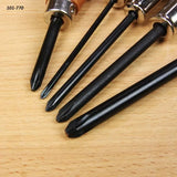 Close-up of five Phillips screwdrivers with black shafts on a wooden surface