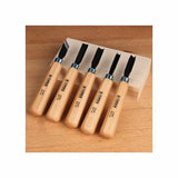 Woodcarving chisel set with wooden handles on a wood block, woodworking tools