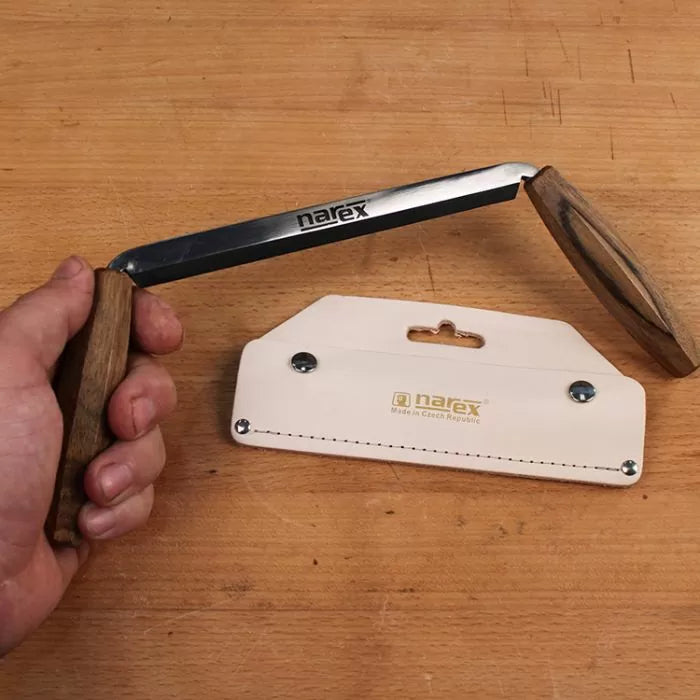 Narex woodworking tenon saw with wooden handle and leather sheath on workbench