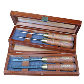 Woodworking chisel set with wooden handles in two open wooden cases, foam inlays visible.