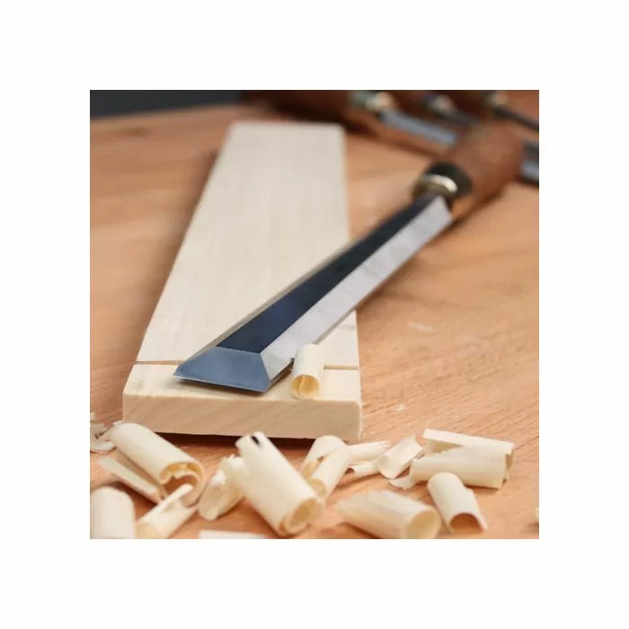 Woodworking chisel on a wooden board with wood shavings, precision hand tool for carpentry