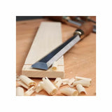 Woodworking chisel on a wooden board with wood shavings, precision hand tool for carpentry