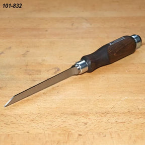 Woodworking marking knife with steel blade and dark wood handle on workbench