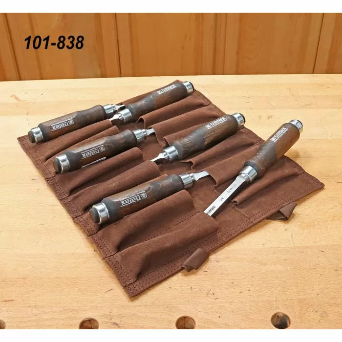 Set of six woodworking chisels with wooden handles in a brown tool roll on a workbench.