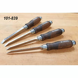 Set of four Narex wood chisels with dark wooden handles on a workbench