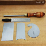 Woodworking scraper set with burnisher, file, and three cabinet scraper blades on workbench