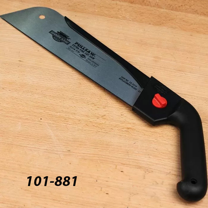 Pull saw with black handle and red knob on a wooden surface, woodworking hand tool