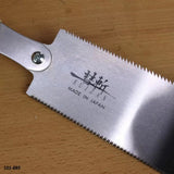 Japanese pull saw Suizan with fine teeth on wood surface, woodworking hand tool