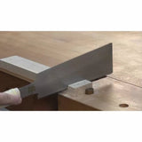 Japanese pull saw cutting wood on a workbench with stop block and guide
